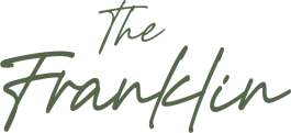 The image displays the words "The Franklin" in green cursive font.